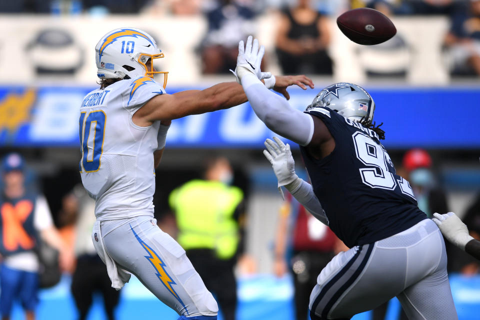 Sep 19, 2021; Inglewood, California, USA; Los Angeles Chargers quarterback <a class="link " href="https://sports.yahoo.com/nfl/players/32676" data-i13n="sec:content-canvas;subsec:anchor_text;elm:context_link" data-ylk="slk:Justin Herbert;sec:content-canvas;subsec:anchor_text;elm:context_link;itc:0">Justin Herbert</a> (10) throws a pass while pressured by Dallas Cowboys defensive tackle <a class="link " href="https://sports.yahoo.com/nfl/players/33463" data-i13n="sec:content-canvas;subsec:anchor_text;elm:context_link" data-ylk="slk:Osa Odighizuwa;sec:content-canvas;subsec:anchor_text;elm:context_link;itc:0">Osa Odighizuwa</a> (97) during the second half at SoFi Stadium. Mandatory Credit: Orlando Ramirez-USA TODAY Sports
