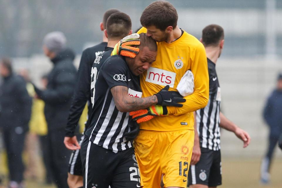 Emotional: Everton Luiz cried as he left the pitch comforted by goalkeeper Filip Kljajic (REUTERS/Miroslav Todorovic)