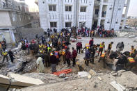 Security officials and rescue workers search bodies at the site of suicide bombing, in Peshawar, Pakistan, Monday, Jan. 30, 2023. A suicide bomber struck Monday inside a mosque in the northwestern Pakistani city of Peshawar, killing multiple people and wounding scores of worshippers, officials said. (AP Photo/Zubair Khan)