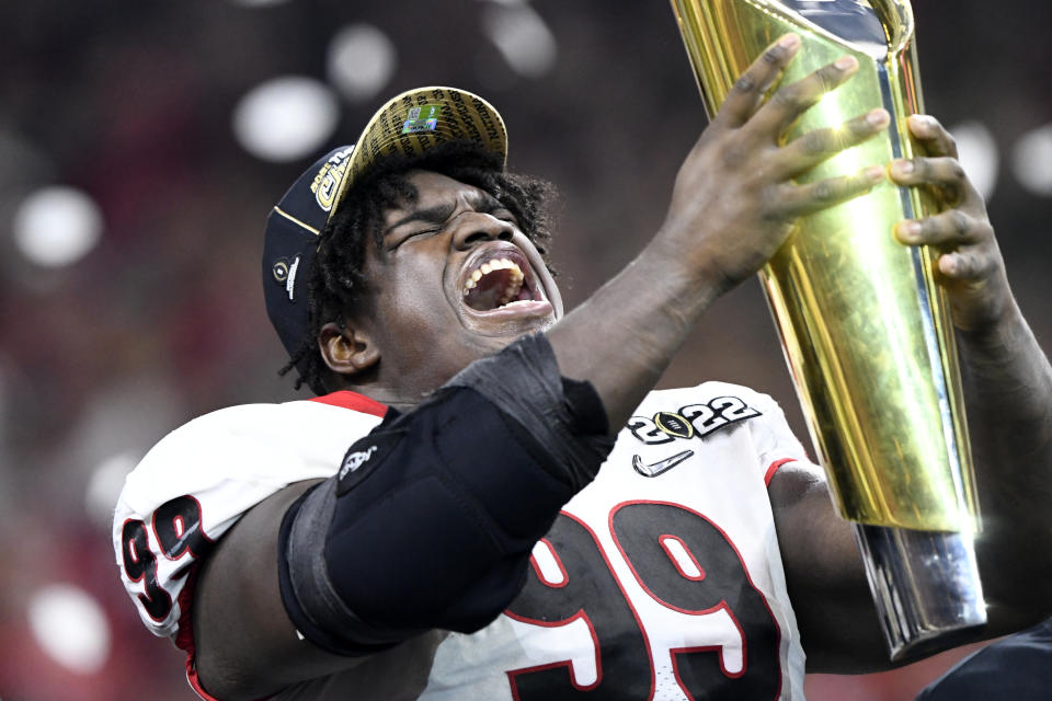 Georgia NT Jordan Davis hoists the National Championship Trophy after beating Alabama. (Photo by Michael Allio/Icon Sportswire via Getty Images)