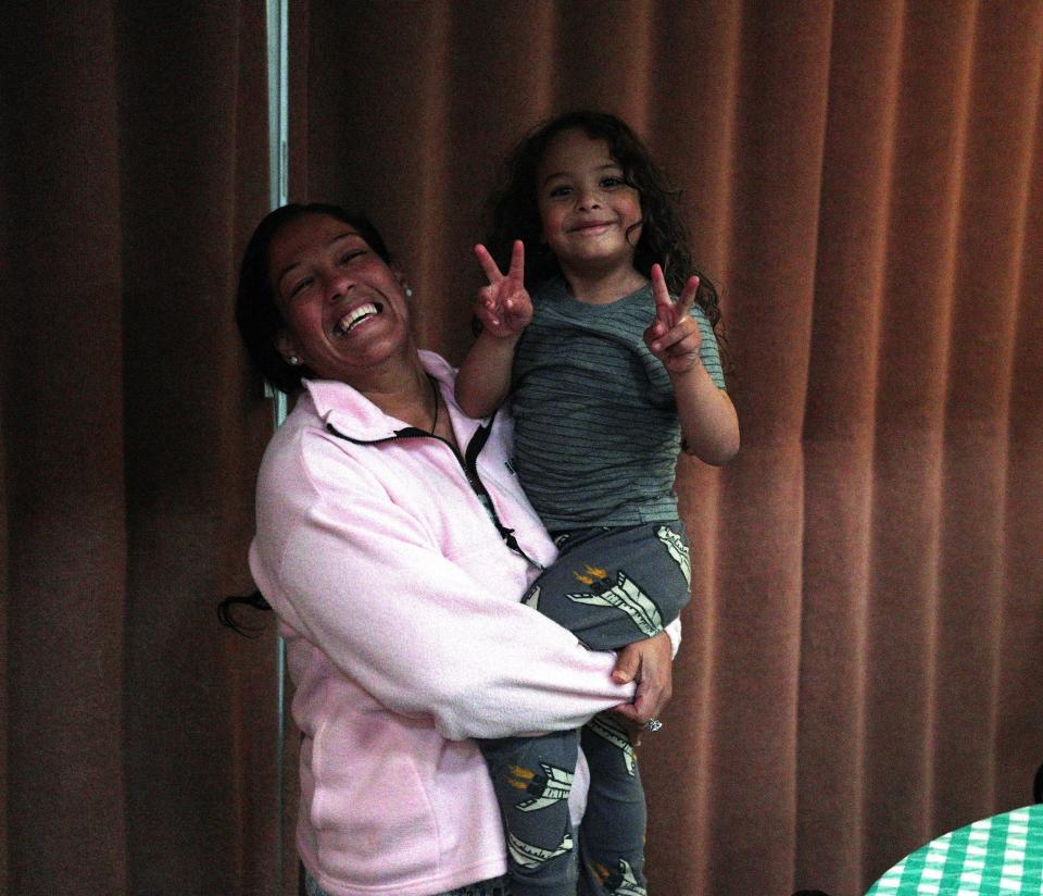 Lizbeth Torres and her son Will Daniel pose for a photo inside the Denver Friends Church shelter for migrants. The Torres family trekked about 3,000 miles from Venezuela to reach the United States.