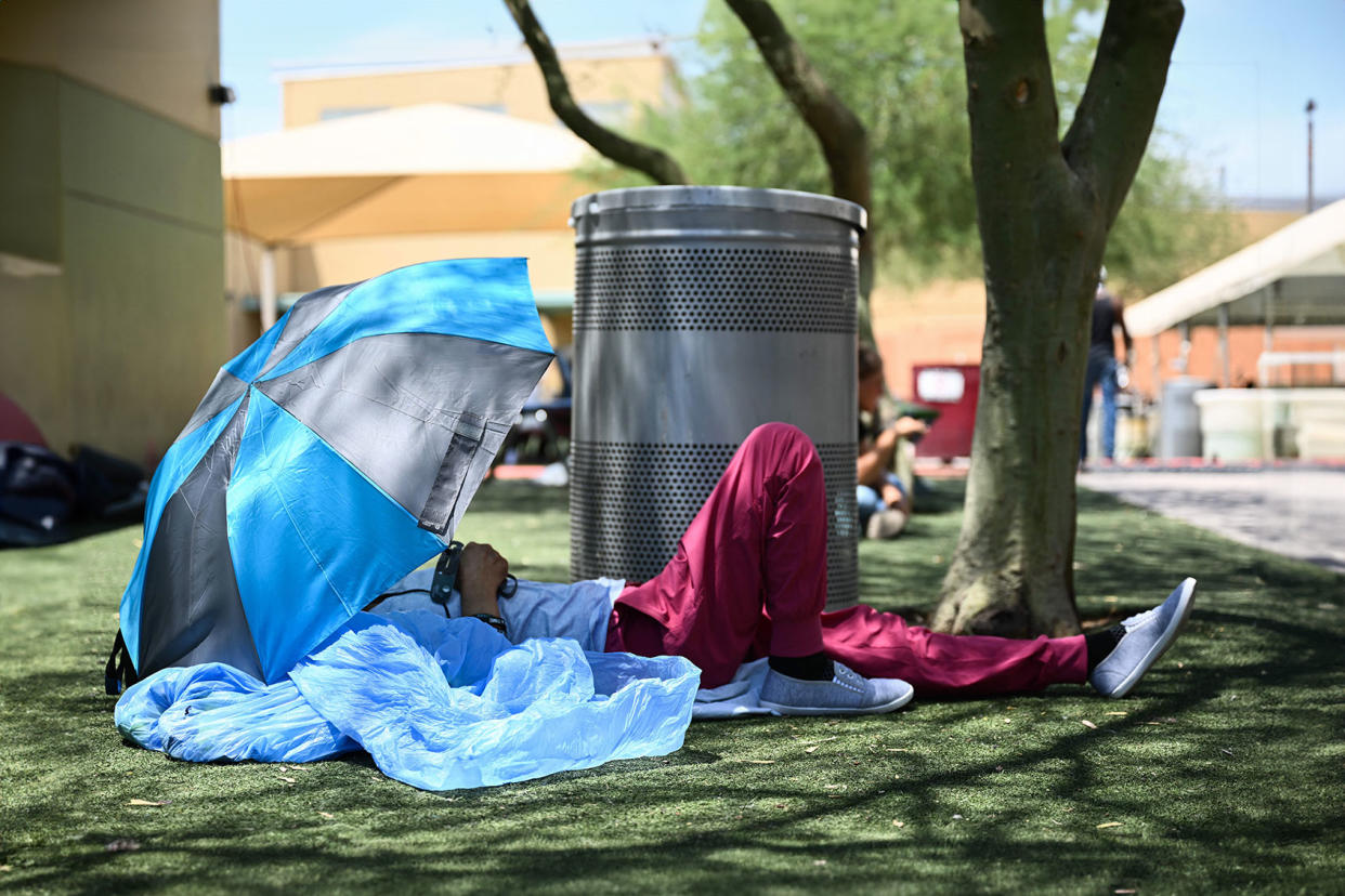 Homeless person resting shade heat wave PATRICK T. FALLON/AFP via Getty Images