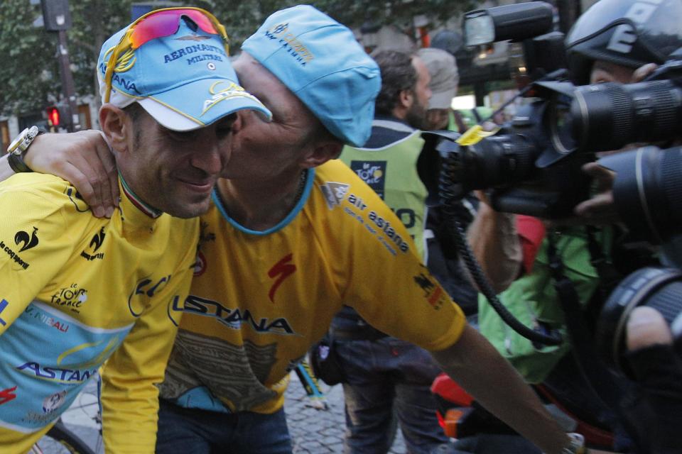 Astana team manager Alexander Vinokourov kisses 2014 Tour de France cycling race winner Italy's Vincenzo Nibali during the team parade of the Tour de France cycling race in Paris, France, Sunday, July 27, 2014. (AP Photo/Christophe Ena)