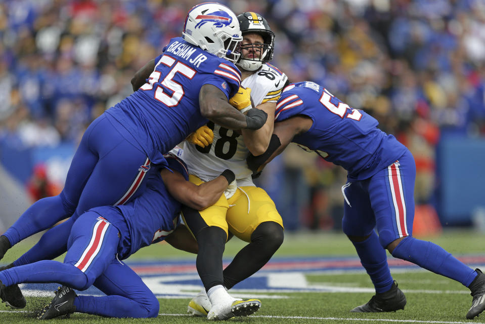 Pittsburgh Steelers tight end Pat Freiermuth (88) is tackled by Buffalo Bills defensive end Boogie Basham (55) and linebacker Tyrel Dodson, right, during the second half of an NFL football game in Orchard Park, N.Y., Sunday, Oct. 9, 2022. (AP Photo/Joshua Bessex)