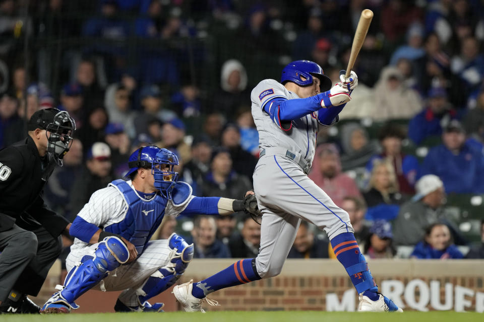 New York Mets' Brandon Nimmo, right, hits a two-run triple during the eighth inning of a baseball game against the Chicago Cubs in Chicago, Thursday, May 25, 2023. (AP Photo/Nam Y. Huh)
