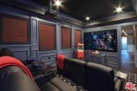 <p>Downstairs, there’s a theatre room with a 90-inch projection screen. (Realtor.com) </p>