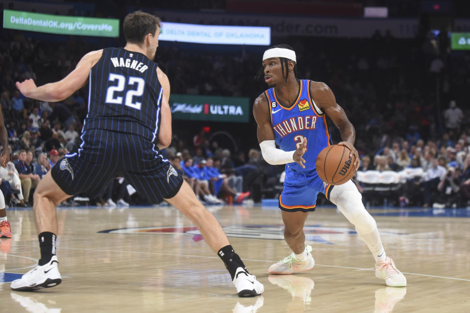 Oklahoma City Thunder guard Shai Gilgeous-Alexander (2) tries to get past Orlando Magic forward Franz Wagner (22) in the second half of an NBA basketball game, Tuesday, Nov. 1, 2022, in Oklahoma City. (AP Photo/Kyle Phillips)