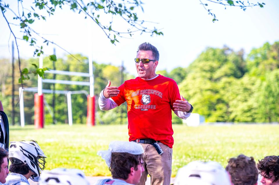 Old Rochester coach Michael Forns speaks to the team at halftime.