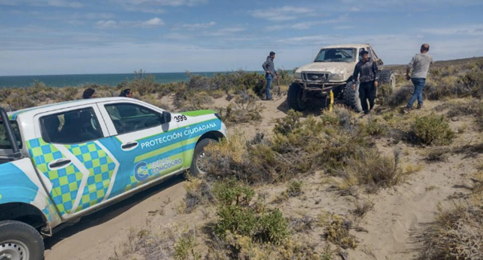 Men searching on the beach for Mr Barría. 