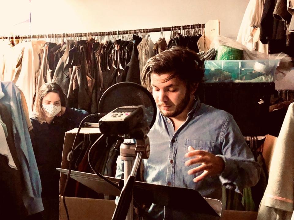 Jason McIntyre, the lead actor in the series, reads a scene in a TNB wardrobe closet that was used as a recording studio, while assistant director Jillian Hanson listens. (Submitted by Matt Carter - image credit)