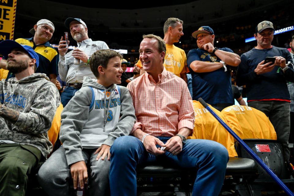 DENVER, CO - JUNE 1: Denver Broncos great Peyton Manning sits with son, Marshall, during the first quarter of the NBA Finals game 1 between the Miami Heat and the Denver Nuggets at Ball Arena in Denver on Thursday, June 1, 2023. (Photo by AAron Ontiveroz/The Denver Post)