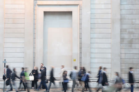 City workers make their way home past the Bank of England in the City of London, Britain October 18, 2017. Picture taken October 18, 2017. REUTERS/Mary Turner