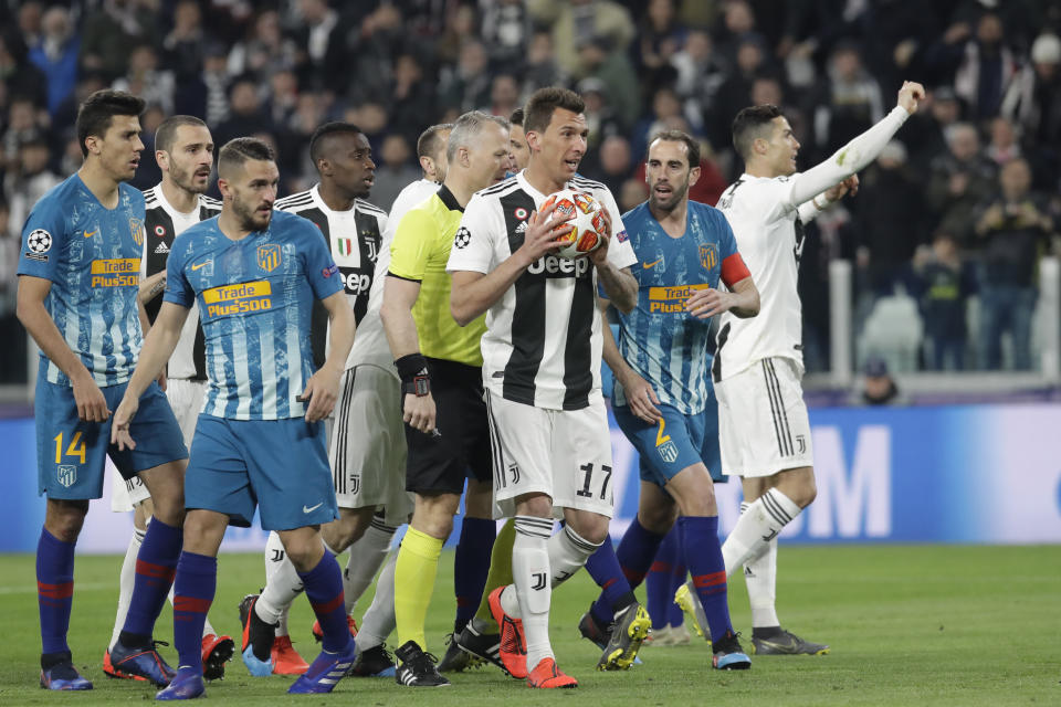 Juventus' Mario Mandzukic holds the ball after a goal was disallowed during the Champions League round of 16, 2nd leg, soccer match between Juventus and Atletico Madrid at the Allianz stadium in Turin, Italy, Tuesday, March 12, 2019. (AP Photo/Luca Bruno)