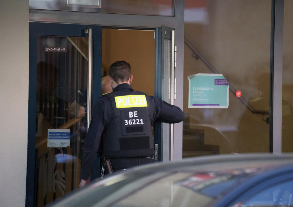 Police officers enter the 'Protestant School Neukoelln' in Berlin, Germany, Wednesday, May 3, 2023. Berlin police say two young children were seriously wounded in an attack at a school in the south of the capital. Police said the victims were girls aged 7 and 8 years. One is in a life-threatening condition, they said in a statement. (Michael Kappeler/dpa via AP)