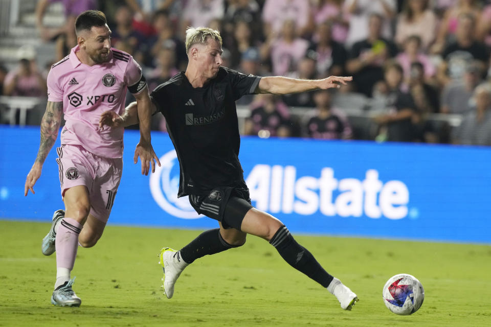 Nashville SC defender Lukas MacNaughton (3) defends Inter Miami forward Lionel Messi (10) during the first half of an MLS soccer match, Wednesday, Aug. 30, 2023, in Fort Lauderdale, Fla. (AP Photo/Marta Lavandier)