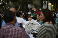 <p>A patient is evacuated from a hospital during a powerful earthquake in Mexico City on Feb. 16, 2018. (Photo: Pedro Pardo/AFP/Getty Images) </p>