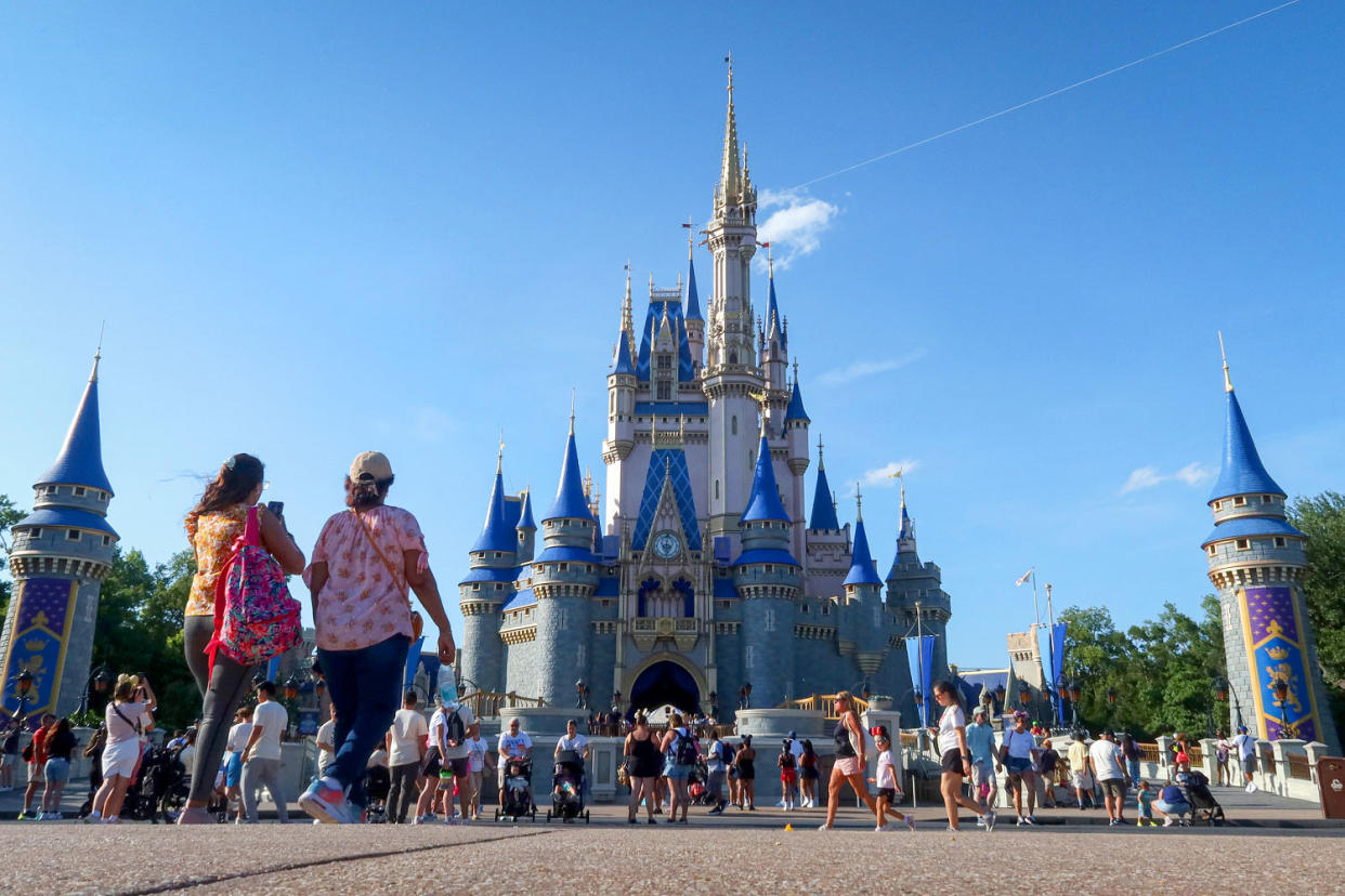 People walk in front of Cinderella's Castle. (Gary Hershorn / Getty Images file)