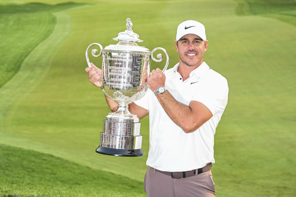 Brooks Koepka poses with the trophy.