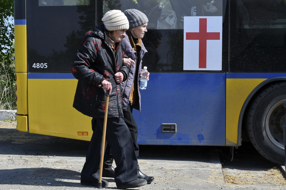 Women board a bus during an evacuation of civilians on a road near Slovyansk, eastern Ukraine, Wednesday, May 4, 2022. (AP Photo/Andriy Andriyenko)