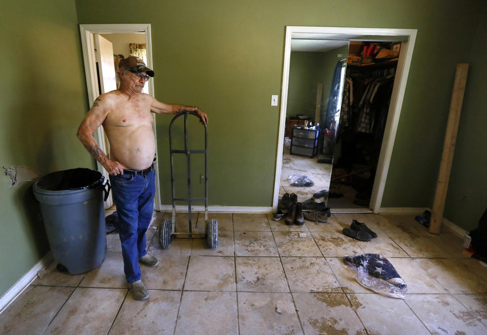 <p>Vietnam veteran Jimmy L. Larmeu pauses to look at his father’s, a WWII veteran, burial flag inside his flood damaged home in Denham Springs, La., Aug. 23, 2016. (Jonathan Bachman/Reuters </p>