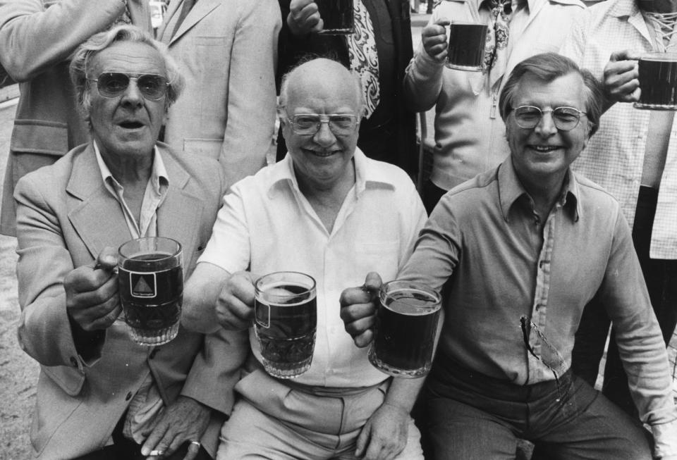 Actors from the television show 'Dad's Army', (L-R) John Le Mesurier, Arthur Lowe and Clive Dunn, holding their pints of being aloft as they celebrate the West End stage production of their show, August 26th 1975. (Photo by Frank Barratt/Keystone/Getty Images)