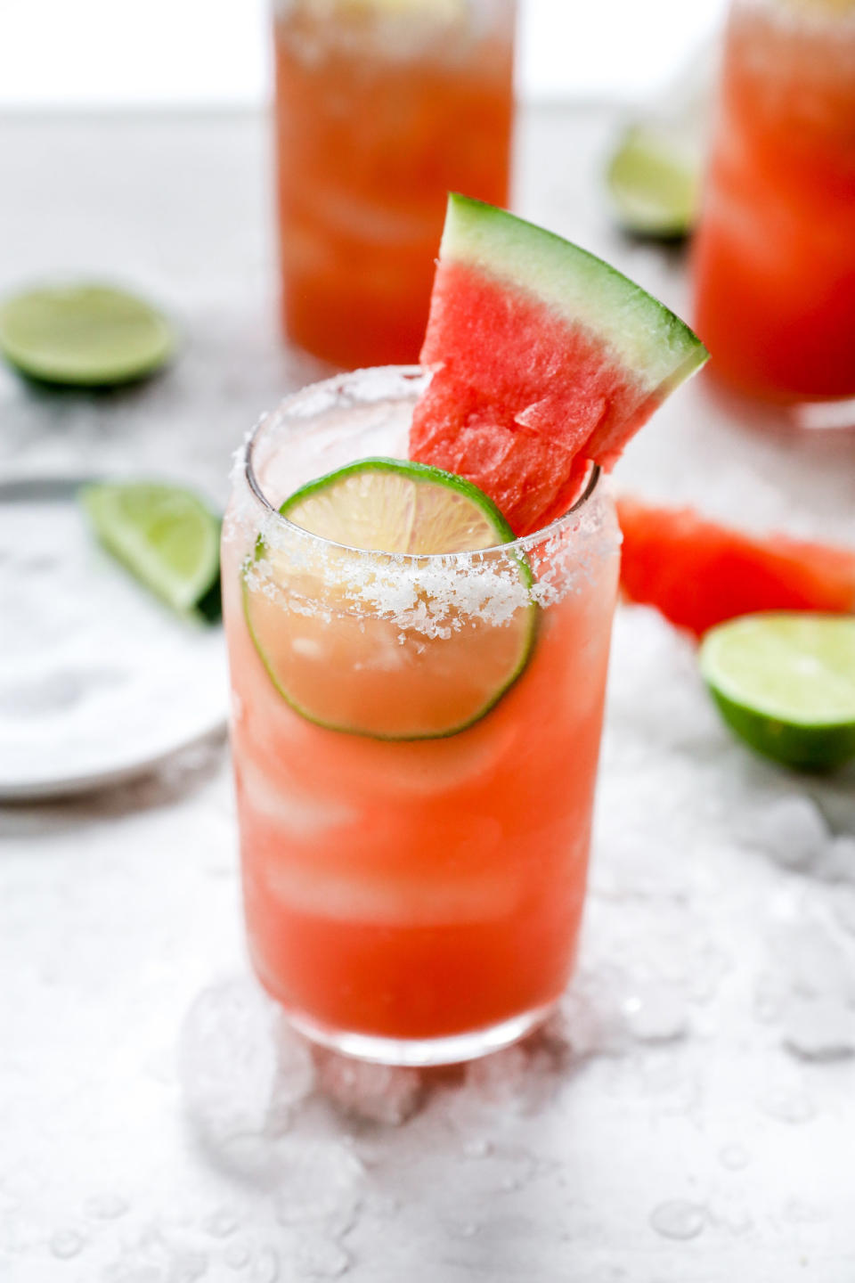 A watermelon cocktail in a tall glass.