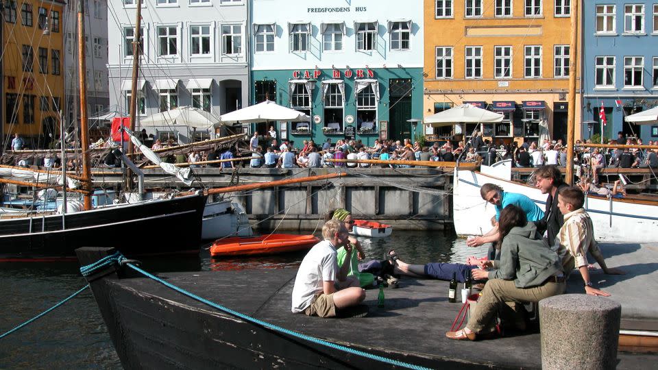 In Copenhagen, you’ll see crowds of young people along the city’s canals enjoying beer from the grocery store. Why not do the same? - Rick Steves