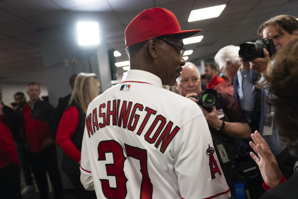 Ron Washington, the new manager of the Los Angeles Angels, talks to a reporter after a news conference Wednesday, Nov. 15, 2023, in Anaheim, Calif. The 71-year-old Washington managed the Texas Rangers from 2007-14, winning two AL pennants and going 664–611. (AP Photo/Jae C. Hong)
