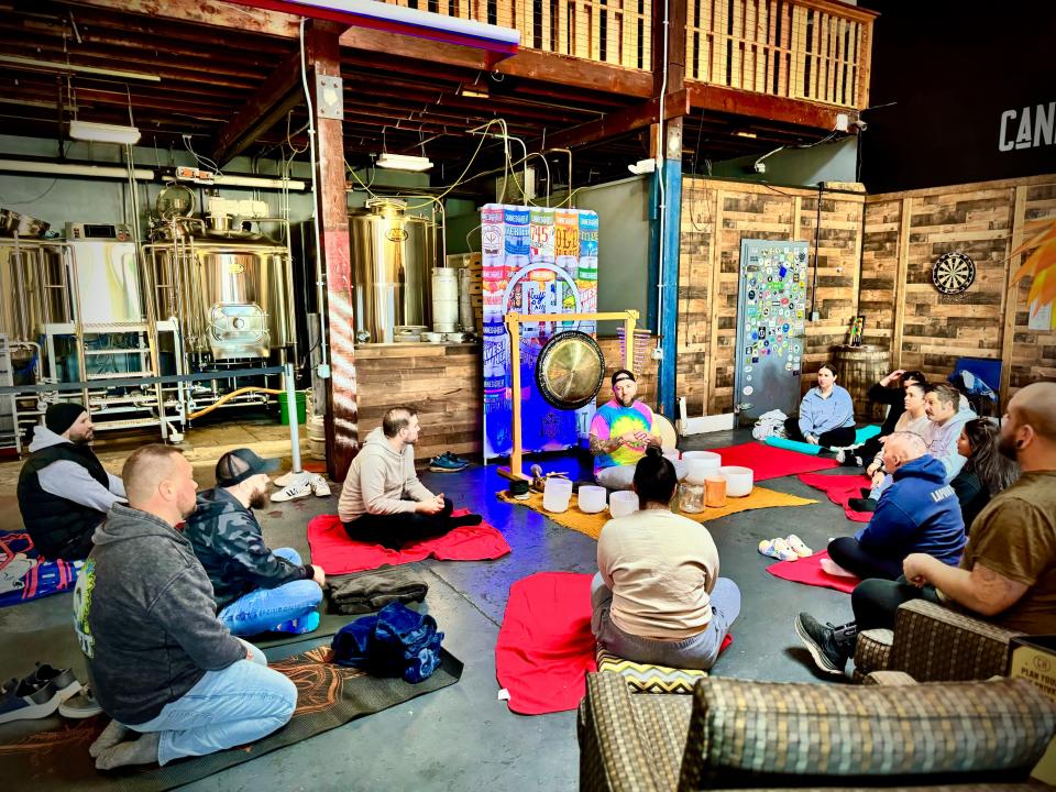 Guests take part in a meditation session at Canned Heat Craft Beer on Ferry Street in Fall River on Sunday, Feb. 25.