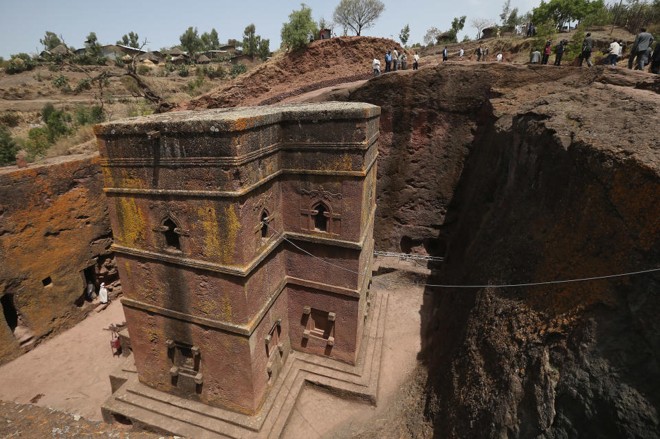 LALIBELA, ETHIOPIA - MARCH 19:  Visitors walk past Bete Giyorgis, also called St. George's Church, at the Lalibela holy sites on March 19, 2013 in Lalibela, Ethiopia. Lalibela is among Ethiopia's holiest of cities and is distinguished by its 11 churches hewn into solid rock that date back to the 12th century. Construction of the churches was begun by Ethiopian Emperor Gebre Mesqel Lalibela, who sought to create an alternative pilgrimage site after the Muslim occupation of Jerusalem. Lalibela was the capital of Ethiopia until the 13th century.  