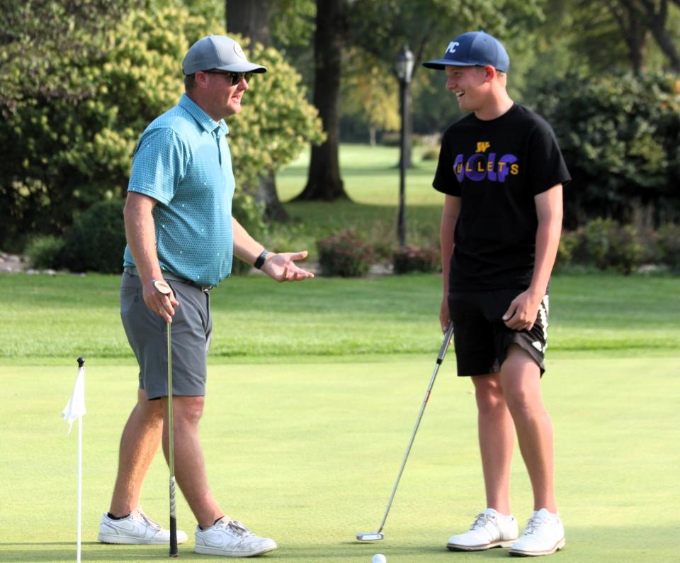 Williamsville boys golf coach Jesse Noelke speaks to freshman Max Fisher at The Rail Golf Course on Wednesday, Oct. 3, 2023.