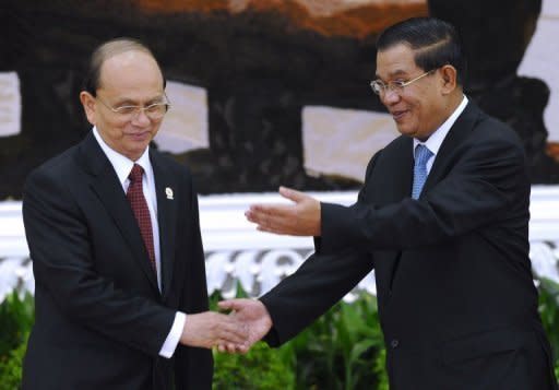 Myanmar's President Thein Sein (L) is greeted by Cambodian Prime Minister Hun Sen at the 20th summit of the Association of Southeast Asian Nation (ASEAN) in Phnom Penh. The group has called for Western sanctions against Myanmar to be lifted, as it holds talks also dominated by North Korea and maritime disputes with China