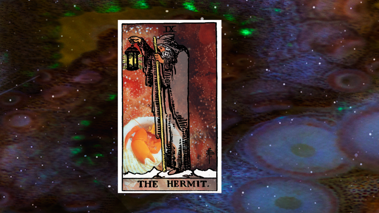 the hermit tarot card over a space themed background