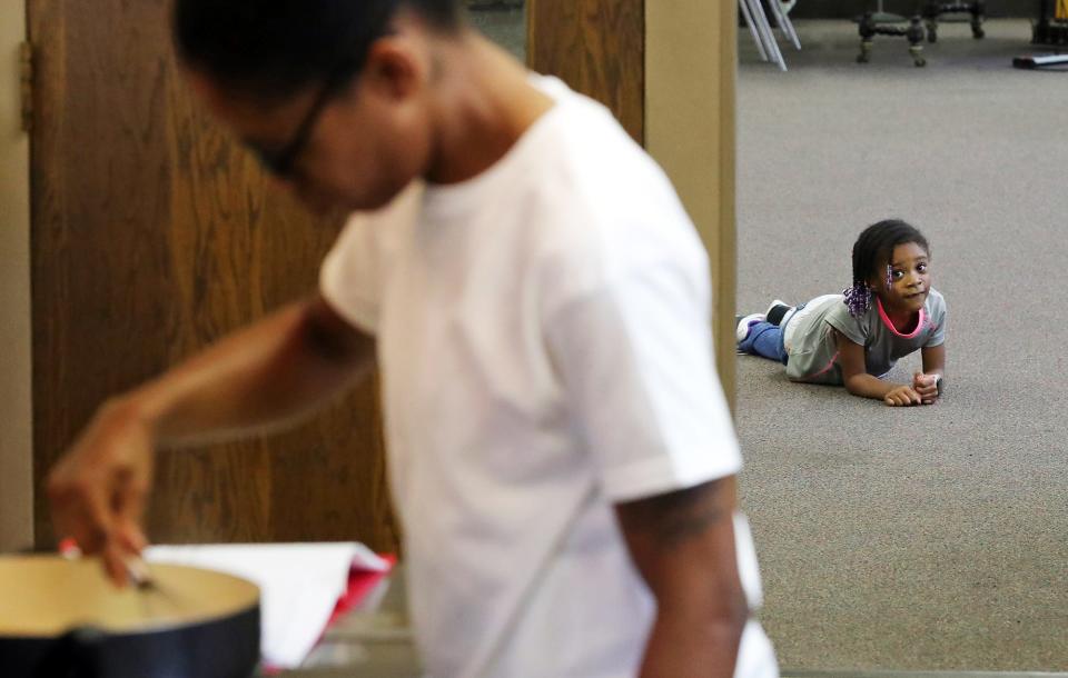 Aliyah, 5, watches as her mother, Terah Coleman, takes a culinary class at Goss Memorial Church run by Jump On Board for Success (JOBS) for young and at-risk mothers who struggle with employment.