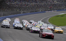 Jimmie Johnson leads the field during a five-wide salute to race fans prior to a NASCAR Cup Series auto race Sunday, March 1, 2020, in Fontana, Calif. (AP Photo/Will Lester)