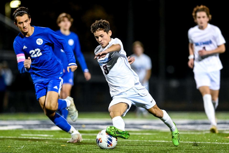 Okemos' Leo Arana, right, moves with the ball as Detroit Catholic Central's Frank Swanson, left, closes in during the second half on Tuesday, Oct. 25, 2022, at East Lansing High School.