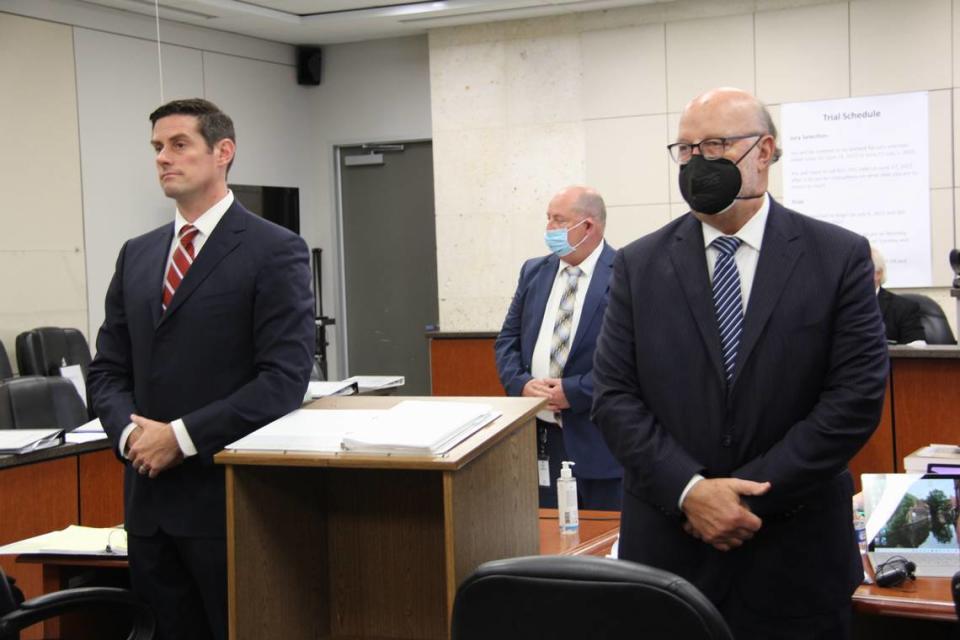 San Luis Obispo County Deputy District Attorney Chris Peuvrelle (left), San Luis Obispo County Sheriff’s Office detective Clint Cole and defense attorney Robert Sanger stand as jurors and spectators enter the trial against Paul Flores on August 11, 2022, in Monterey County Superior Court in Salinas.