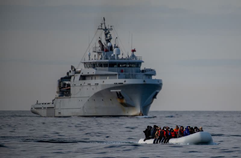 Migrants cross the English Channel in small boats