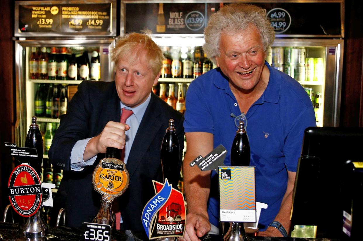 Tim Martin, Chairman of JD Wetherspoon with Prime Minister Boris Johnson during a visit to Wetherspoons Metropolitan Bar in London: PA