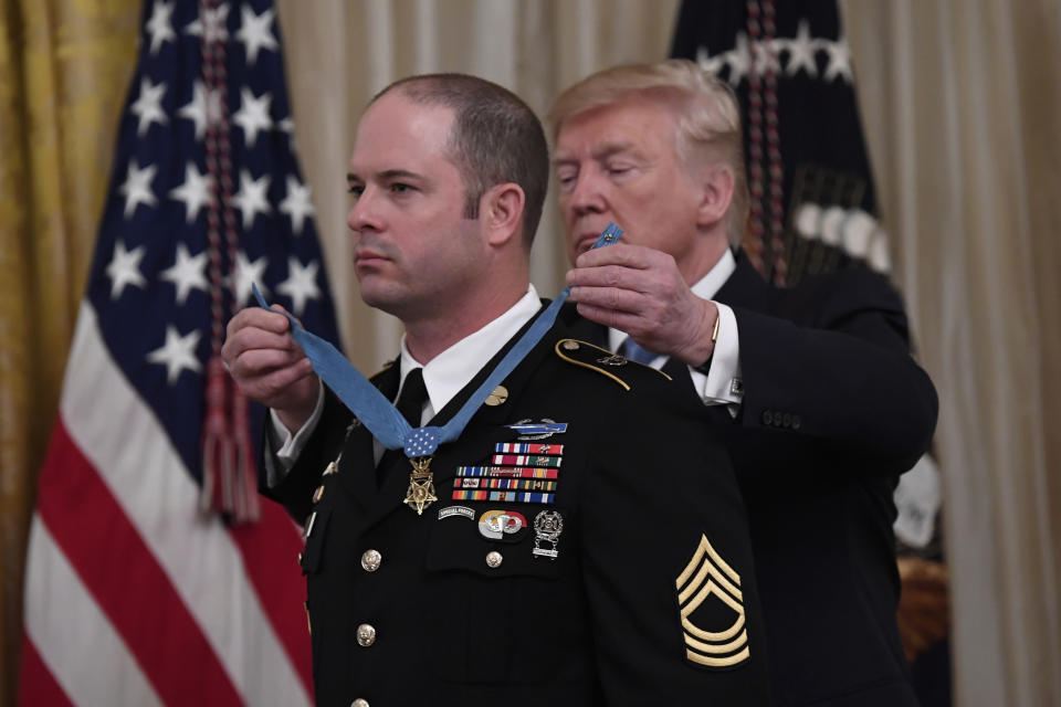 President Donald Trump, right, presents Army Master Sgt. Matthew Williams, left, currently assigned to the 3rd Special Forces Group, with the Medal of Honor during a ceremony in the East Room of the White House in Washington, Wednesday, Oct. 30, 2019. (AP Photo/Susan Walsh)