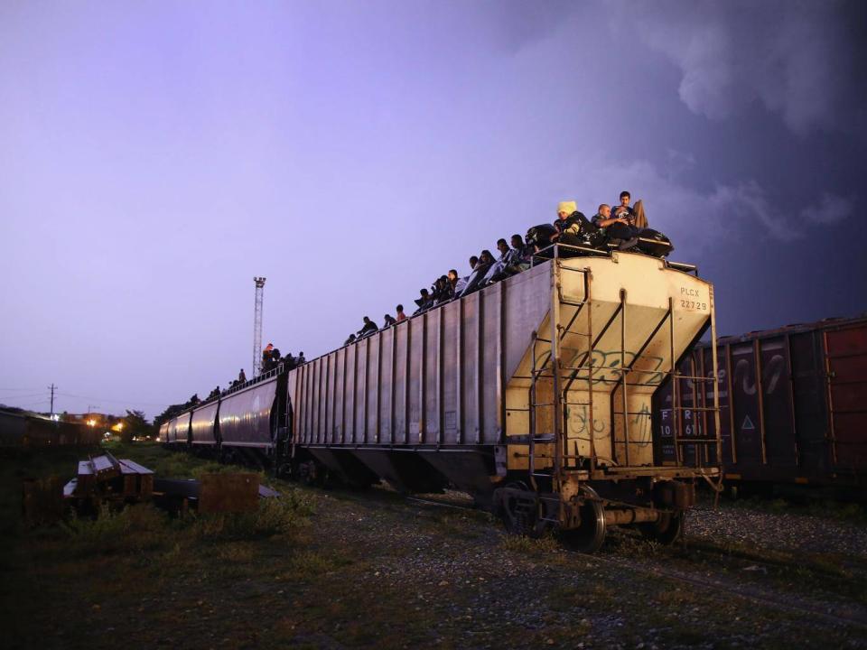 Central American migrants sit atop a freight train known as La Bestia (Getty Images/John Moore)