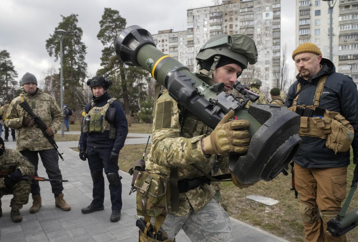 A Ukrainian Territorial Defence Forces member holds an NLAW anti-tank weapon in the outskirts of Kyiv, Ukraine, Wednesday, March 9, 2022. Authorities announced a new ceasefire on Wednesday to allow civilians to escape from towns around the capital, Kyiv, as well as the southern cities of Mariupol, Enerhodar and Volnovakha, Izyum in the east and Sumy in the northeast. Previous attempts to establish safe evacuation corridors have largely failed due to attacks by Russian forces.