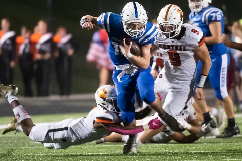Spring Grove's Andrew Osmun picks up a first down on a quarterback run during the third quarter against Central York at Papermakers Stadium on Friday, Oct. 8, 2021, in Jackson Township.