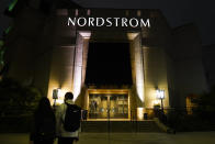 Two pedestrians walk near a closed street entrance to a Nordstrom department store at the Grove mall in Los Angeles, Thursday, Dec. 2, 2021, where a recent smash-and-grab robbery took place. Prosecutors and retailers are pushing back on assertions by California’s governor and attorney general that they have enough tools to combat shoplifting. California Retailers Association president Rachel Michelin says shoplifting has been a growing problem. (AP Photo/Jae C. Hong)