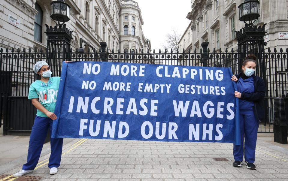 <p>Nurses and NHS workers from the campaign group NHS Workers Say No protest about pay outside Downing Street </p> (PA Wire)