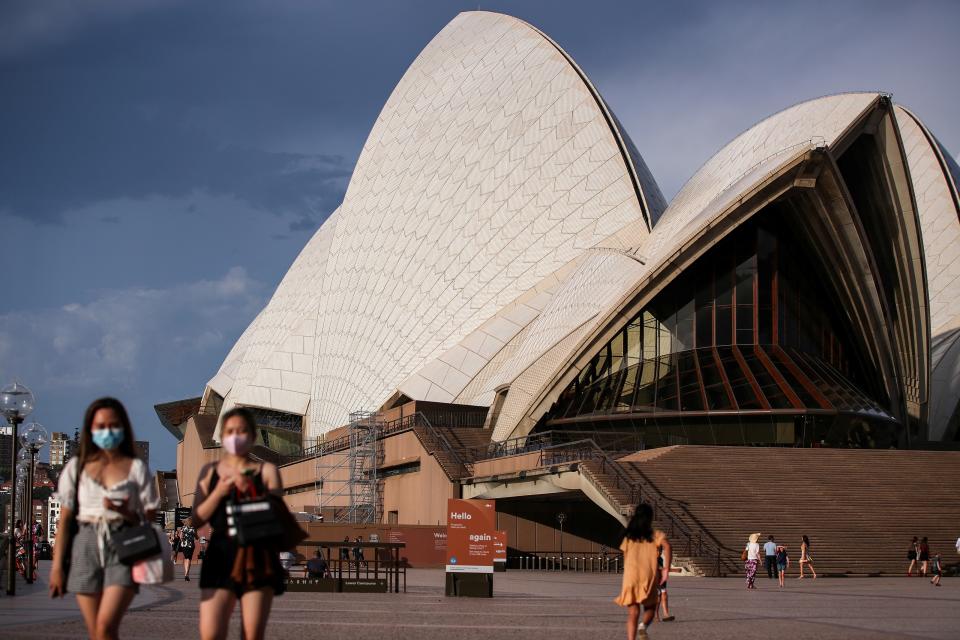 SYDNEY, Jan. 14, 2021 -- People walk past the Sydney Opera House in Sydney, Australia, Jan. 14, 2021. Australia's biggest city of Sydney recorded five locally acquired cases of COVID-19 on Tuesday, as authorities urged the public to get tested and increase openness and transparency with contact tracers. (Photo by Bai Xuefei/Xinhua via Getty) (Xinhua/Bai Xuefei via Getty Images)