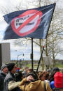 Atlantic City casino workers fly an anti-smoking flag during a rally in Trenton N.J., Friday, April 5, 2024, after the United Auto Workers and casino workers filed a lawsuit challenging New Jersey's clean indoor air law that exempts casino workers from its protections. (AP Photo/Wayne Parry)
