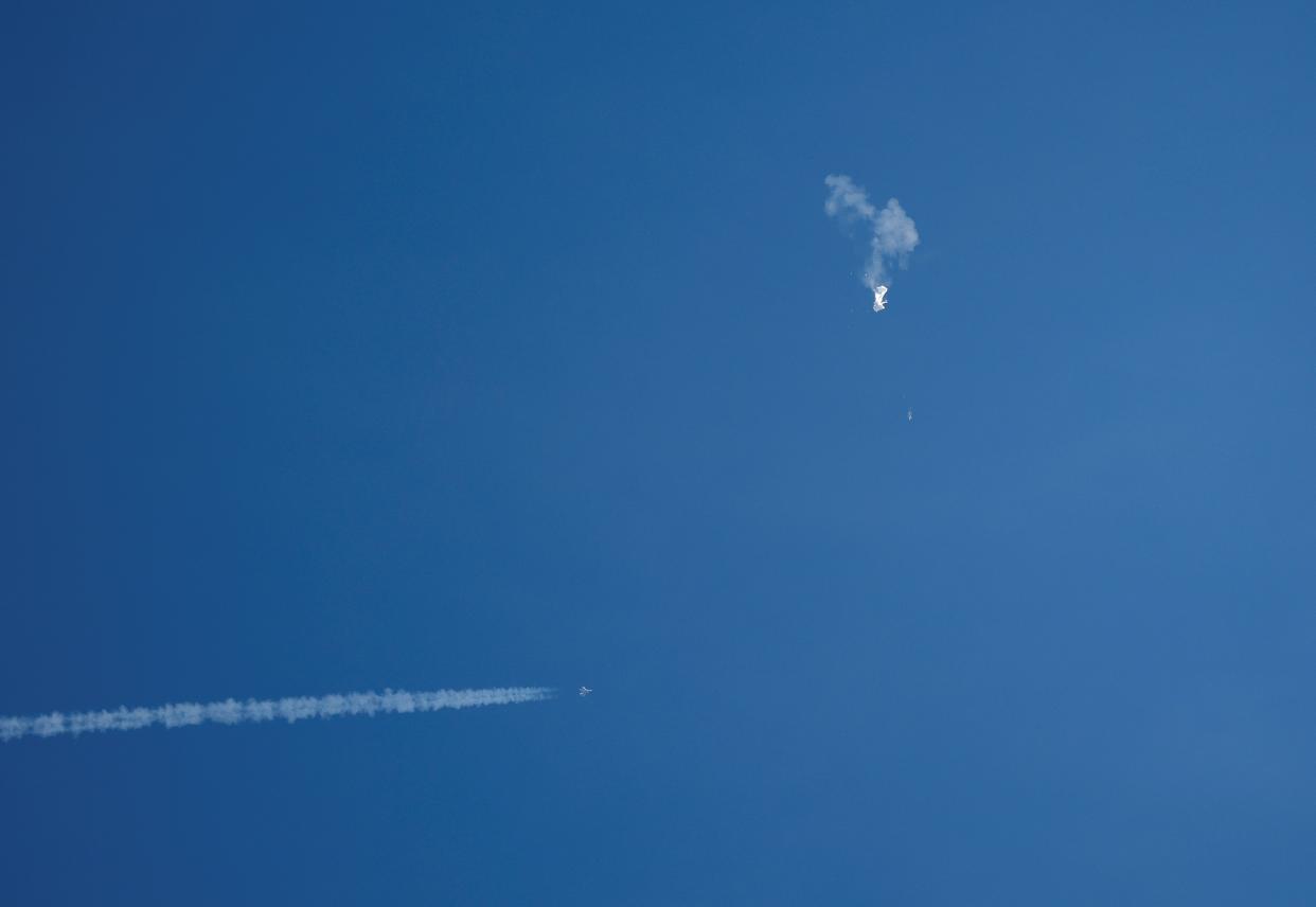 A jet flies by a suspected Chinese spy balloon after shooting it down off the coast in Surfside Beach, South Carolina, U.S. February 4, 2023 (REUTERS)