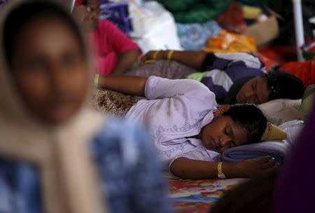 Rohingya migrants who arrived recently by boat rest at a temporary shelter in Kuala Langsa, in Indonesia's Aceh Province May 25, 2015. REUTERS/Darren Whiteside