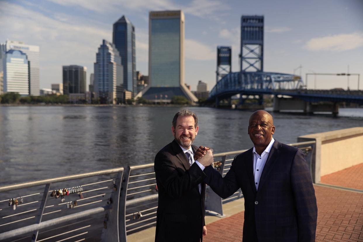 Jewish Community Alliance CEO Adam Chaskin (left) and First Coast YMCA President and CEO Eric Mann, shown Aug. 15 on the Southbank Riverwalk in Jacksonville, have launched a unity initiative that includes a speaker series and 5k.